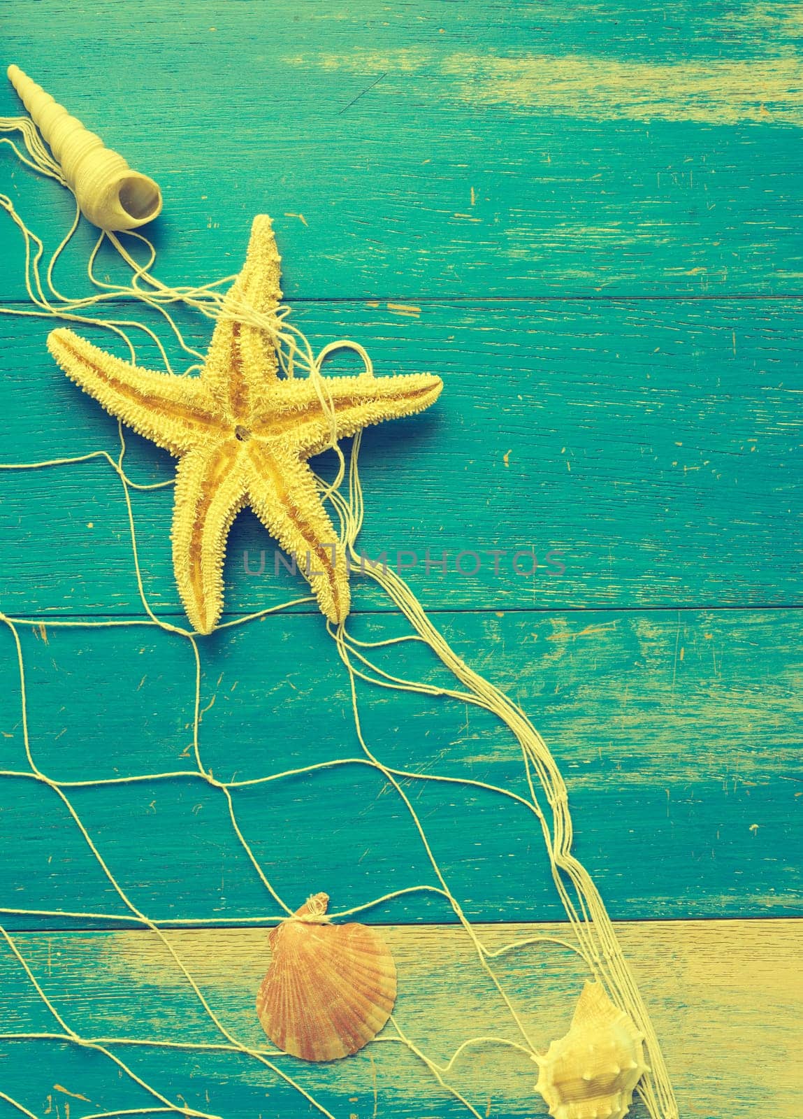 Old weathered wood texture with a fishing net, seafood restaurant or travel vacation concept background