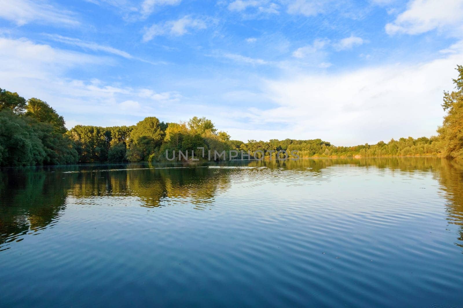 idyllic water landscape, lake with trees around