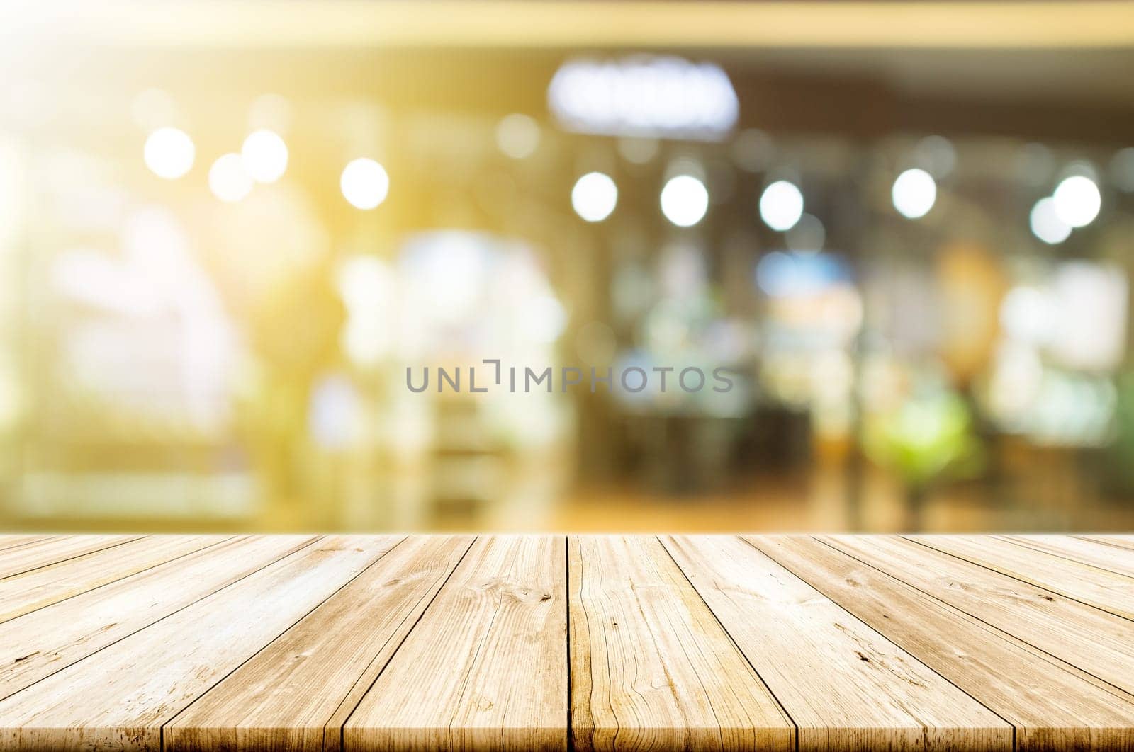 Empty wooden table top with blurred restaurant or cafe light background. can be used product display.