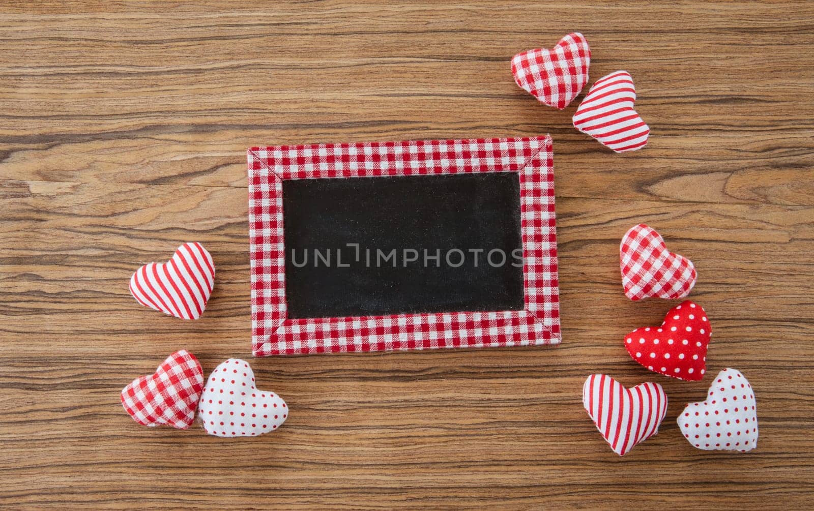 Small panel with colorful hearts on a wooden background