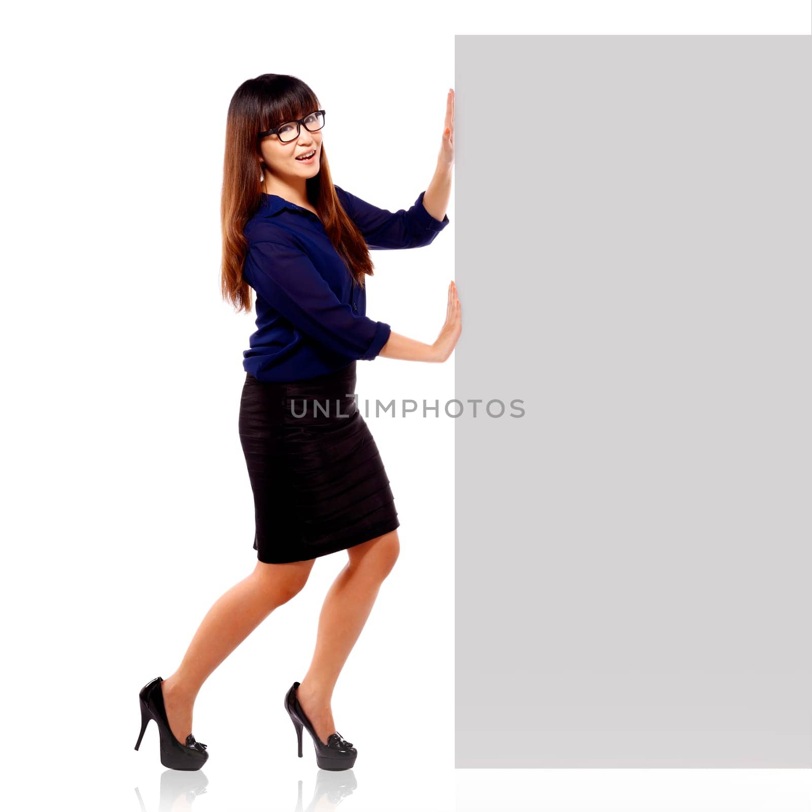 Pretty asian brunette businesswoman in happy face showing an empty blankboard isolated on white background
