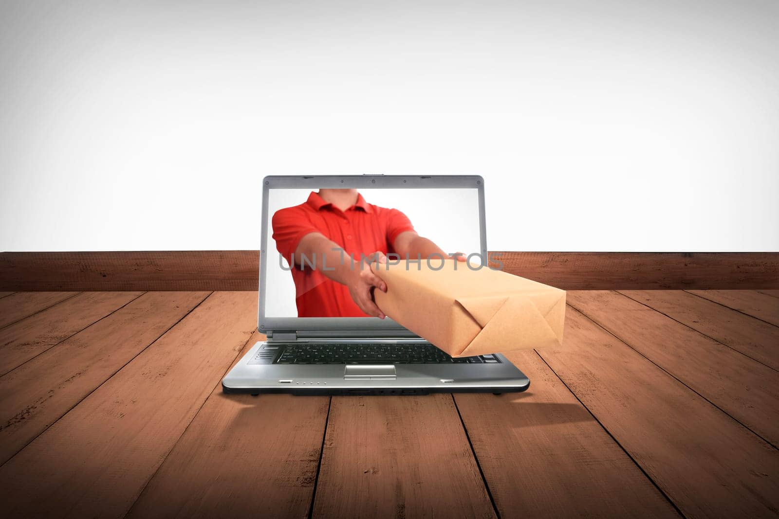 Hand giving a box out of laptop screen. Online shopping concept