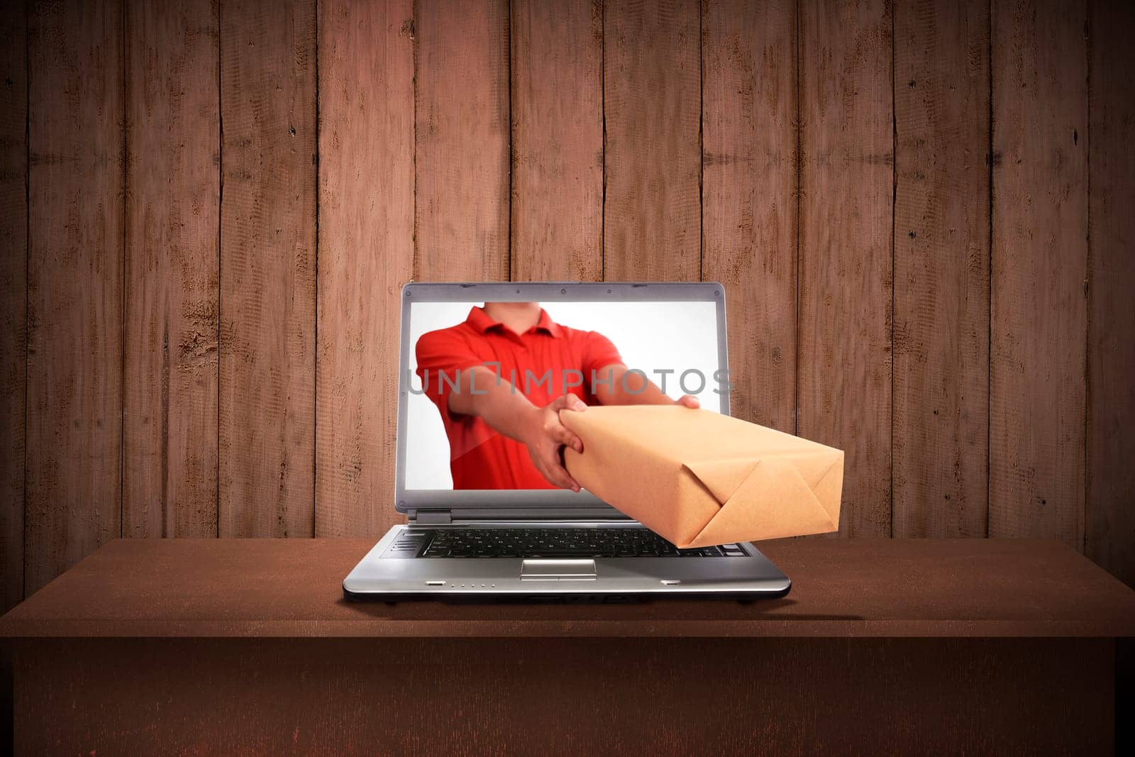 Hand giving a box out of laptop screen. Online shopping concept