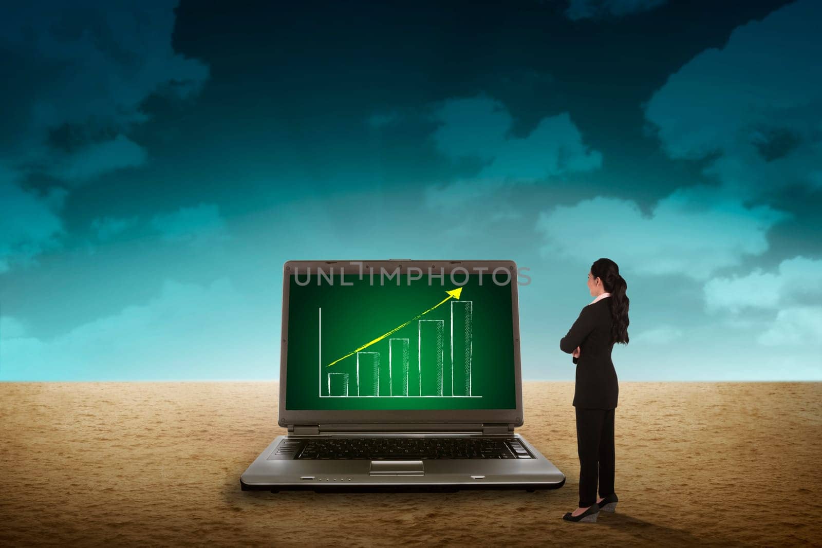 Business person looking giant laptop on the desert. Wireless concept
