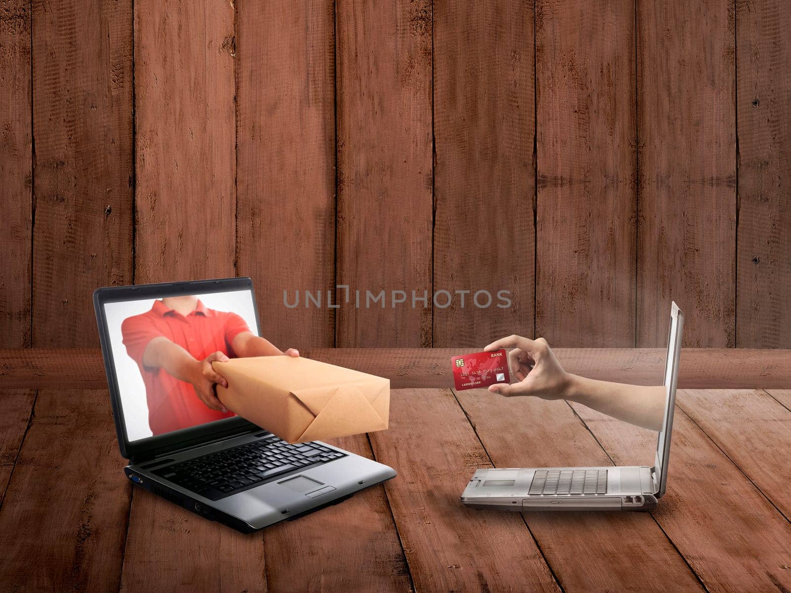 Hand giving a box out of laptop screen. Online shopping concept