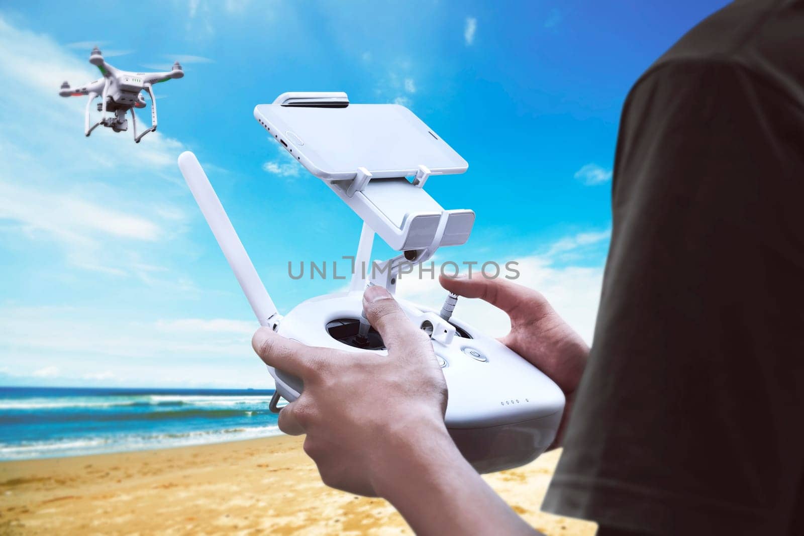 Male pilot controlling drone with remote control
