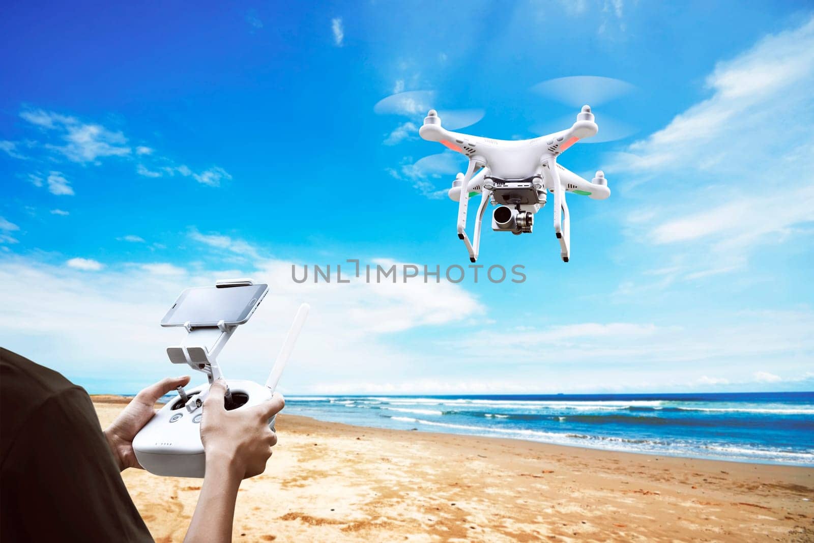 Male pilot controlling drone with remote control