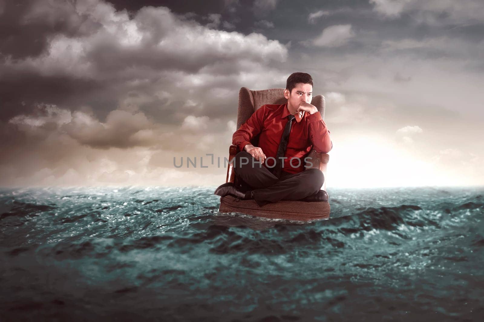 Businessman sitting on an armchair in the middle of the sea. He thinking something