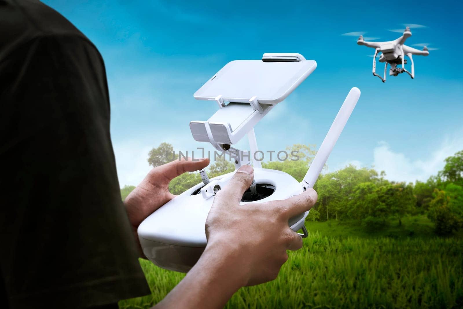 Man playing with drone with blue sky background