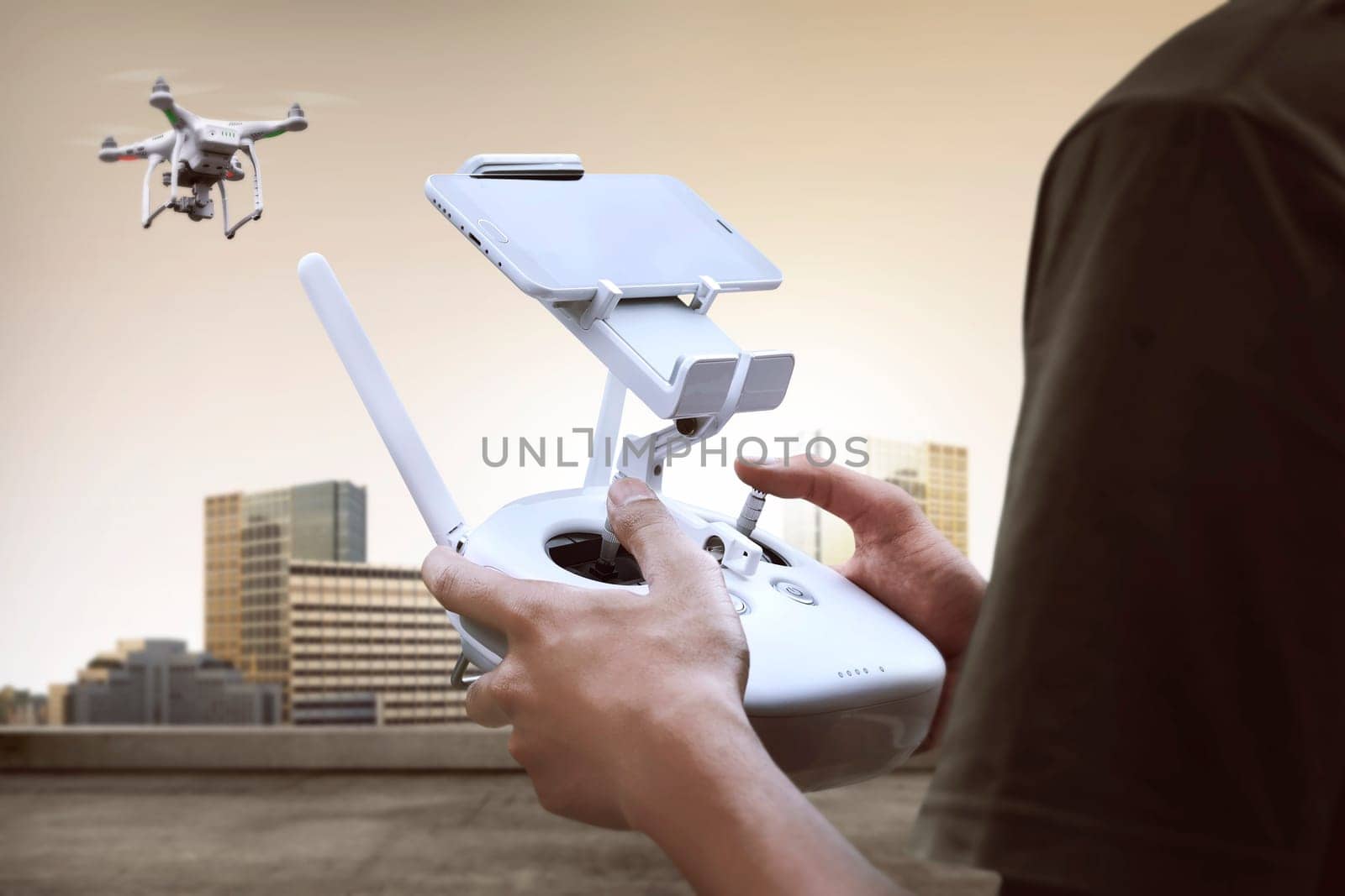 Male pilot controlling drone with remote control