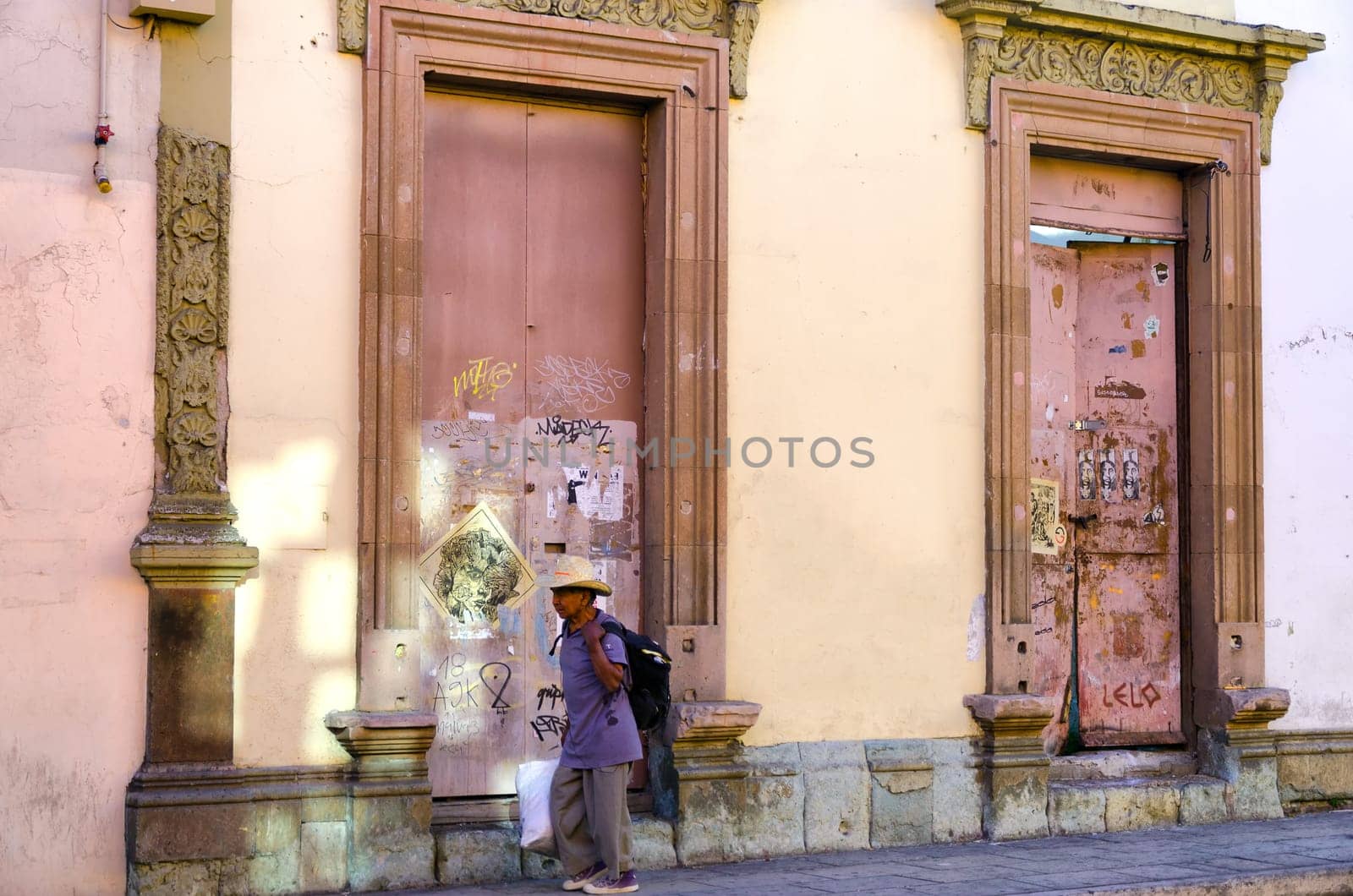 OAXACA, MEXICO - MARCH 4: Pink facade with a man passing by in downtown in Oaxaca, Mexico on March 4, 2017