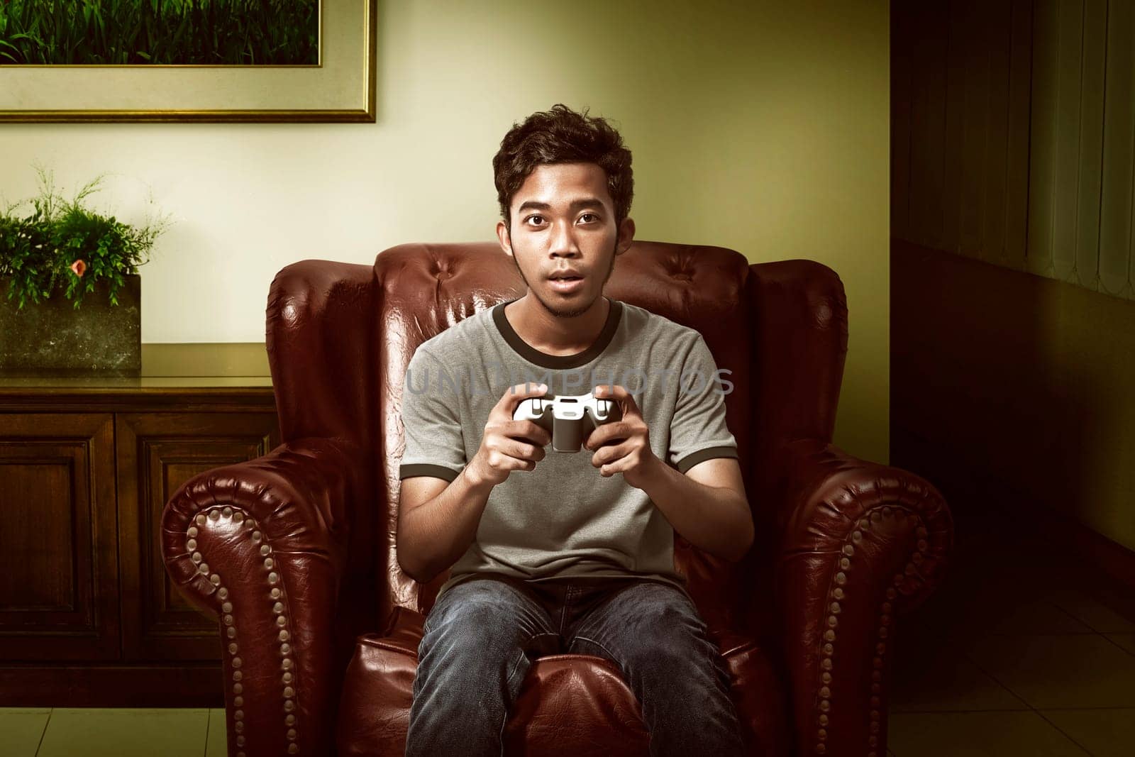 Asian man playing game on the living room