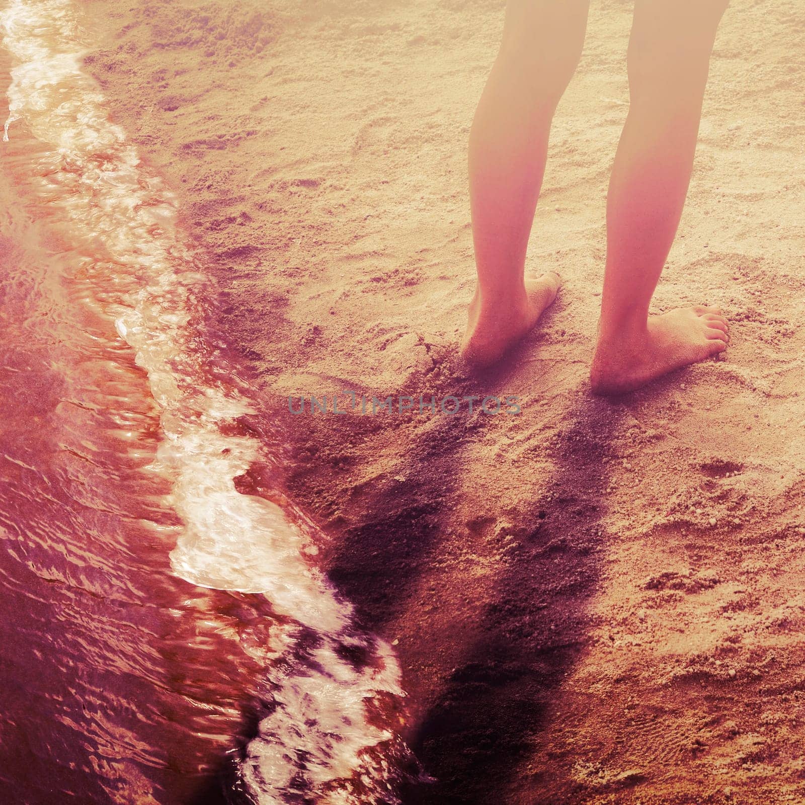 Feet of woman playing in the beach when sunny day
