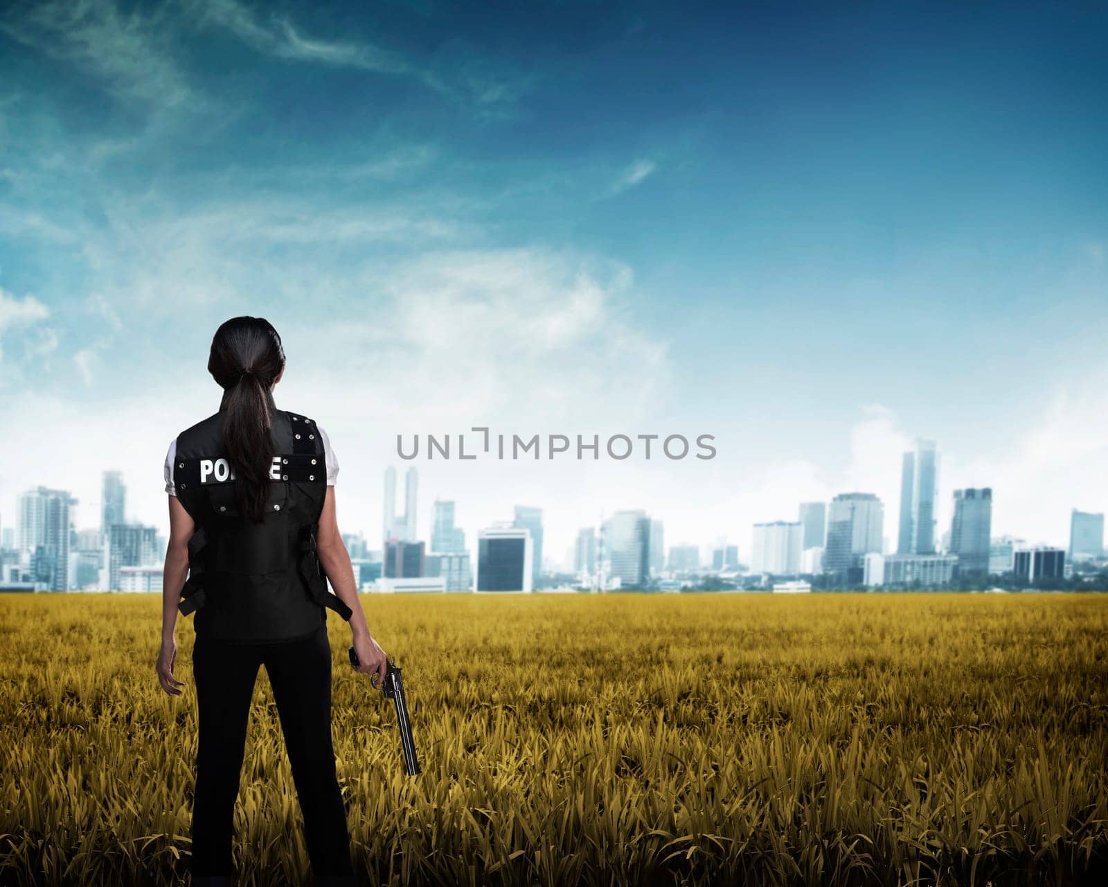 Police woman looking the city in the middle of field. Police concept