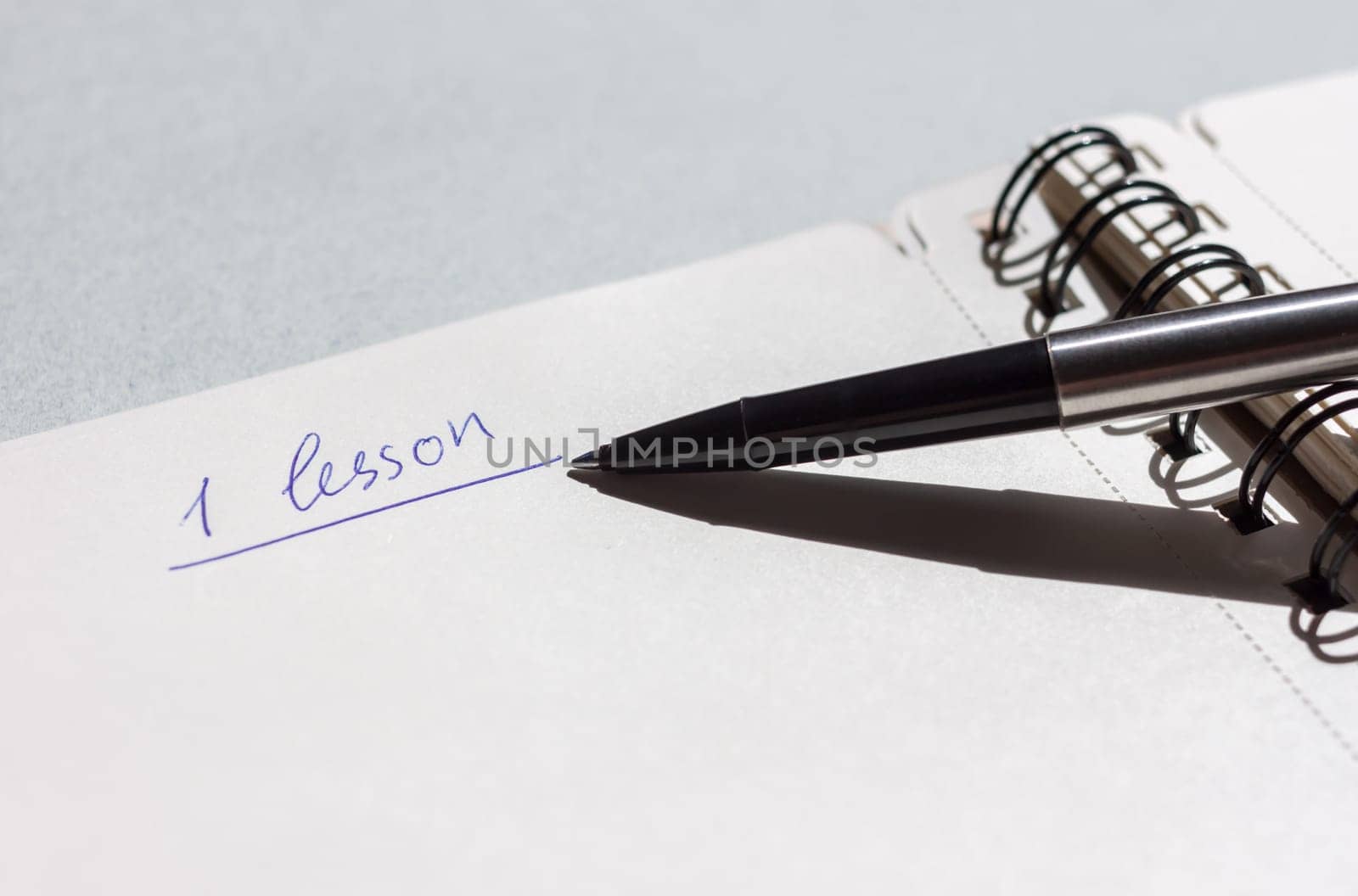 first lesson open notebook with pen can be background