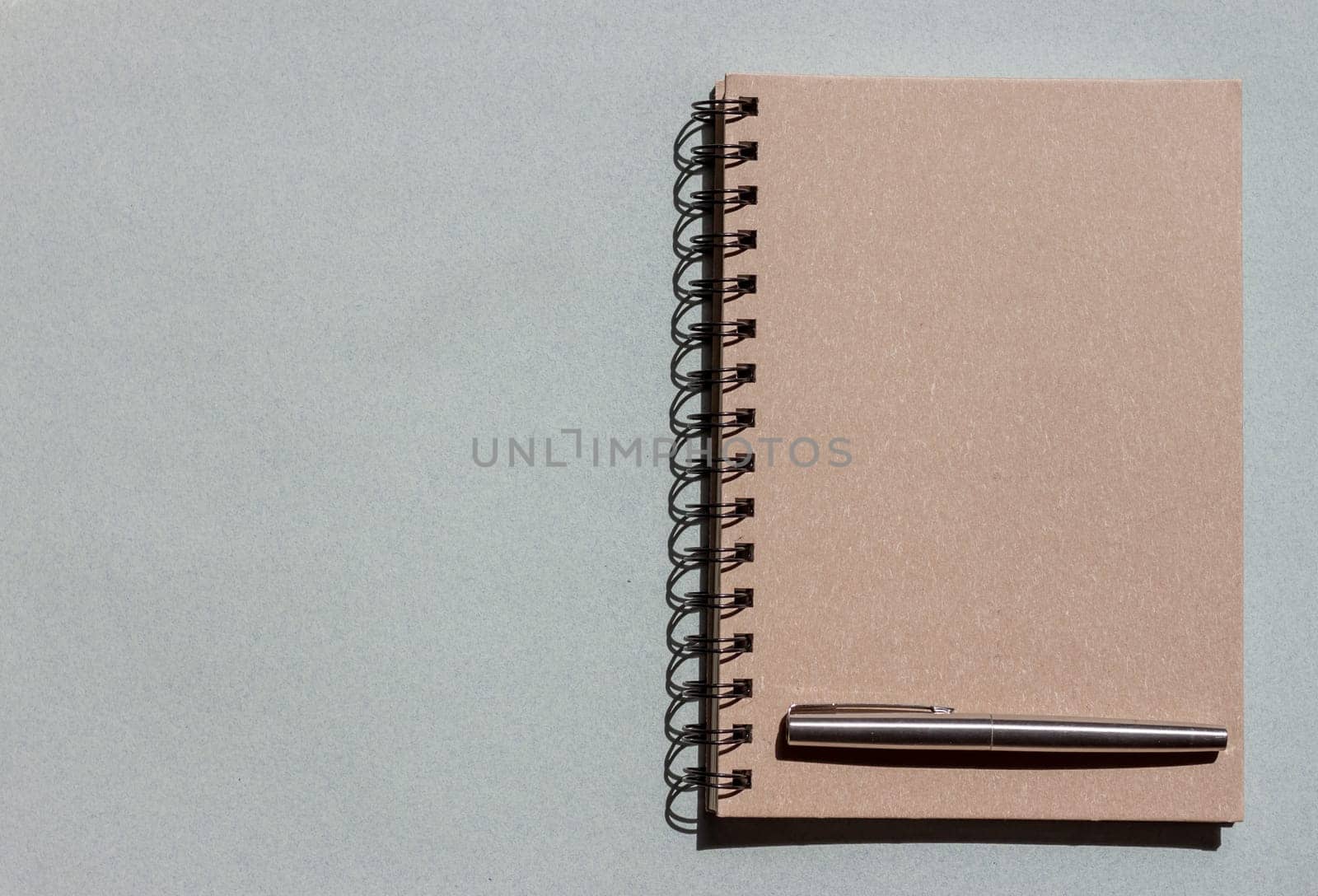 top view craft notebook and pen on blue background