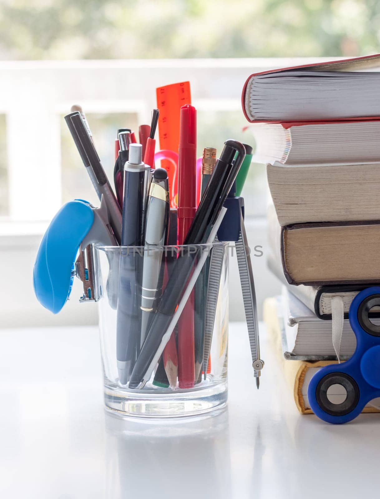 work desk with stationery and books light background