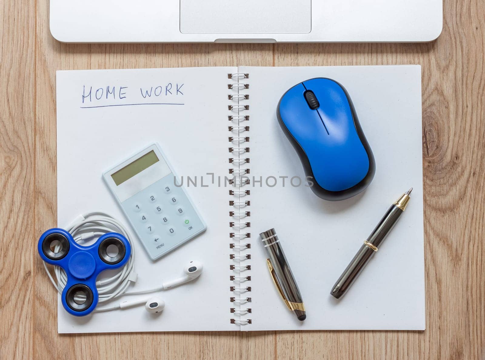open notebook waiting for home work distracting spinner and laptop