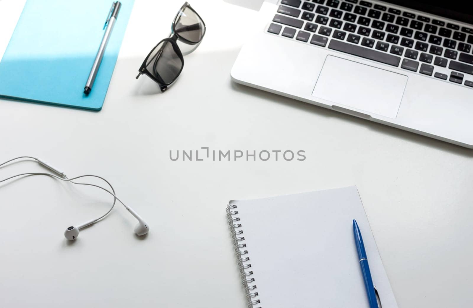 work desk with laptop notebook and glasses