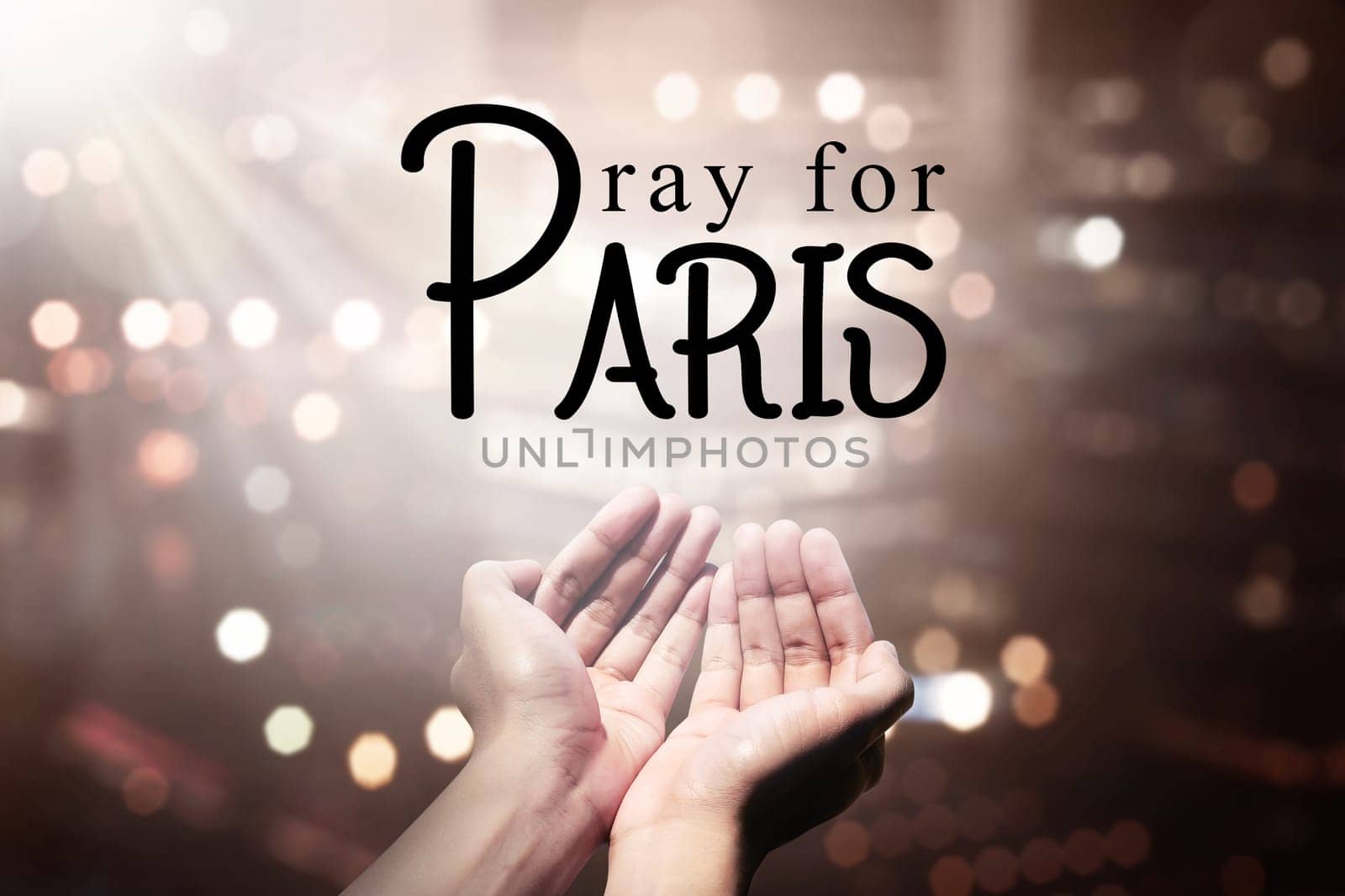 Human hand pray for paris incident, with blur city background