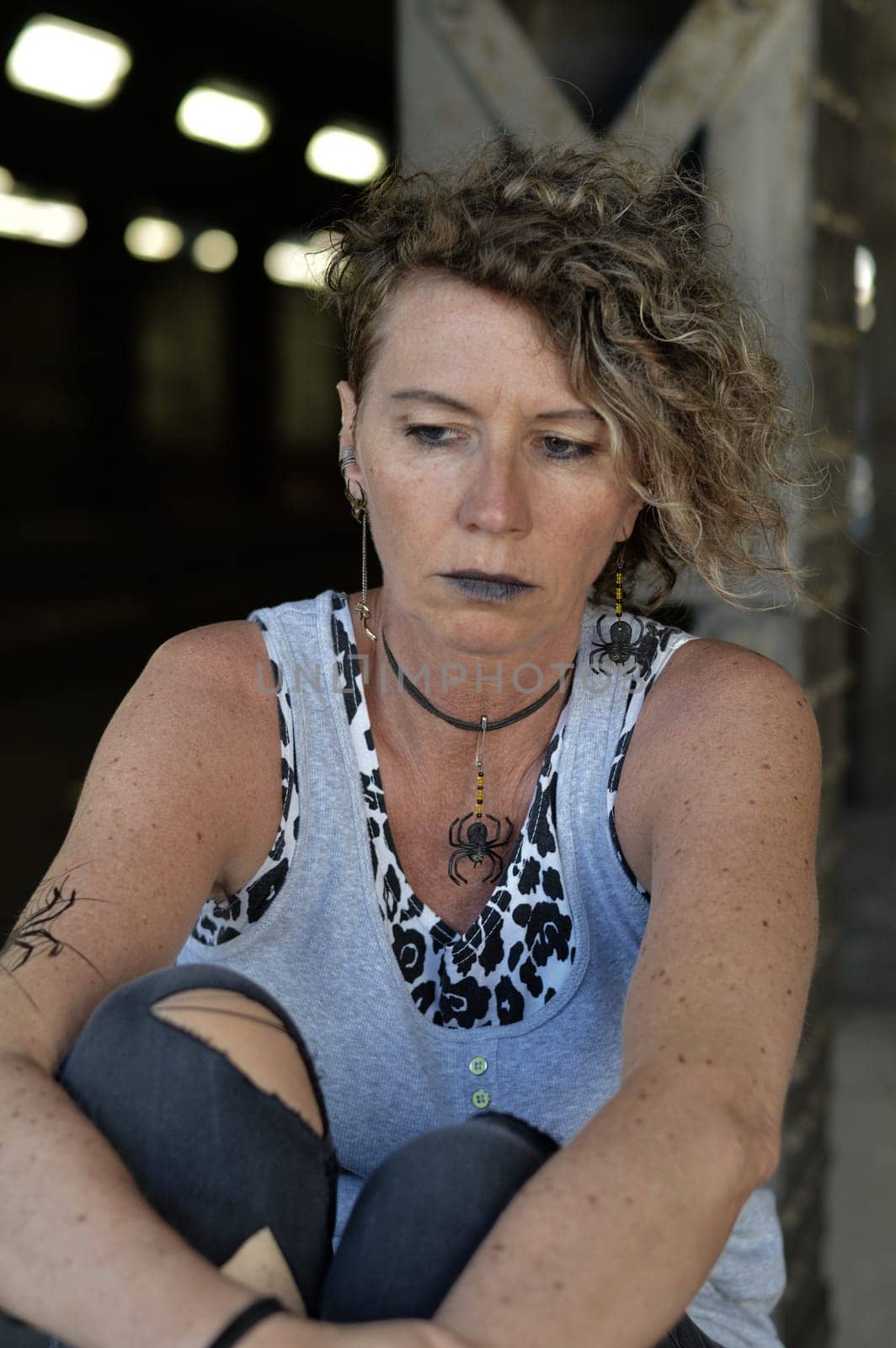 Middle-aged punk stares gloomy at herself