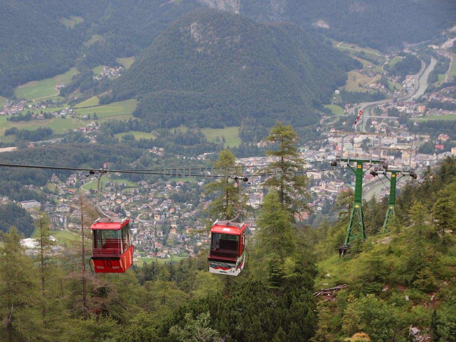 Two Red Ski Gondol Lift Carrier with Mountain Valley Background