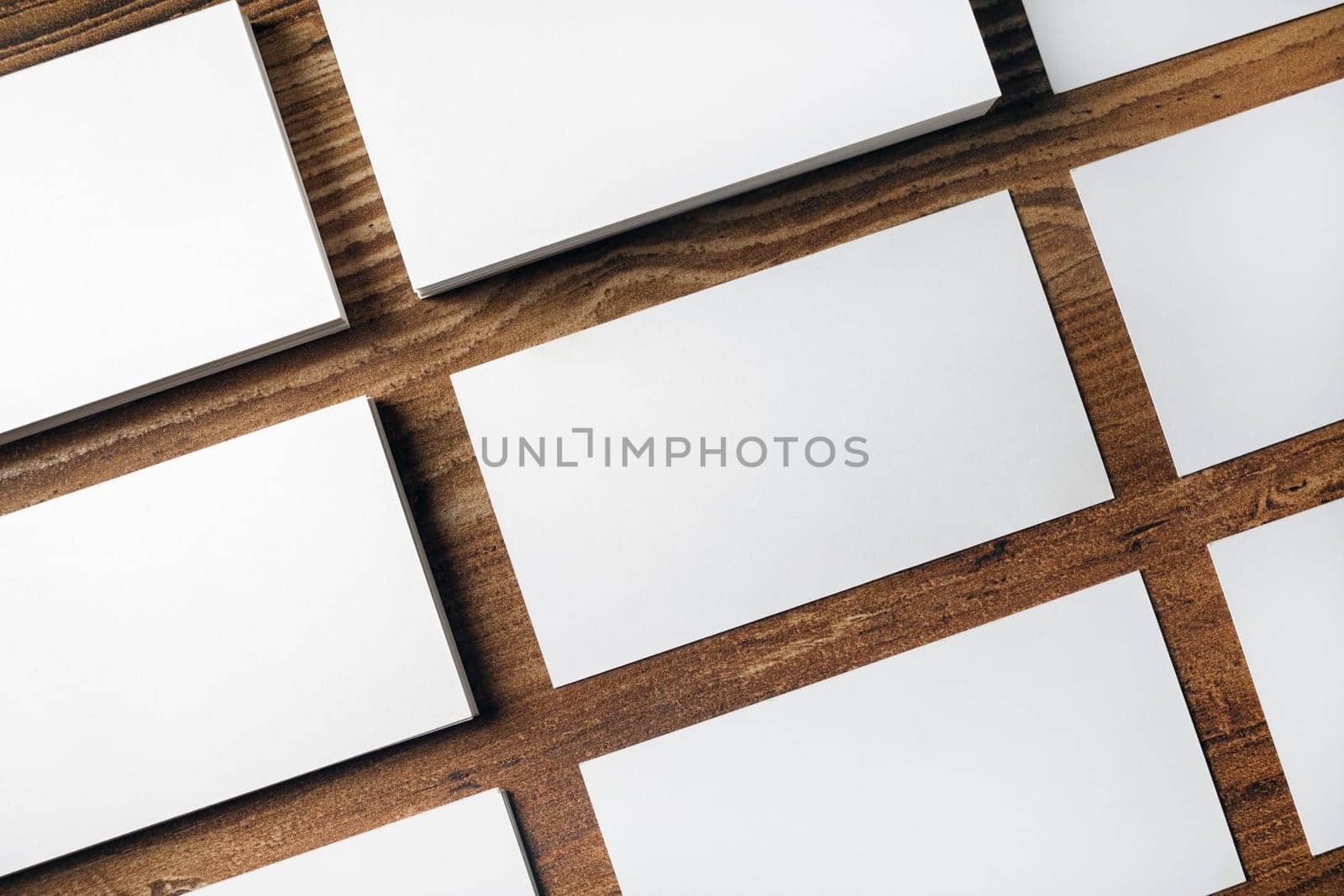 Many blank business cards on wooden background. Mockup for ID. Top view.