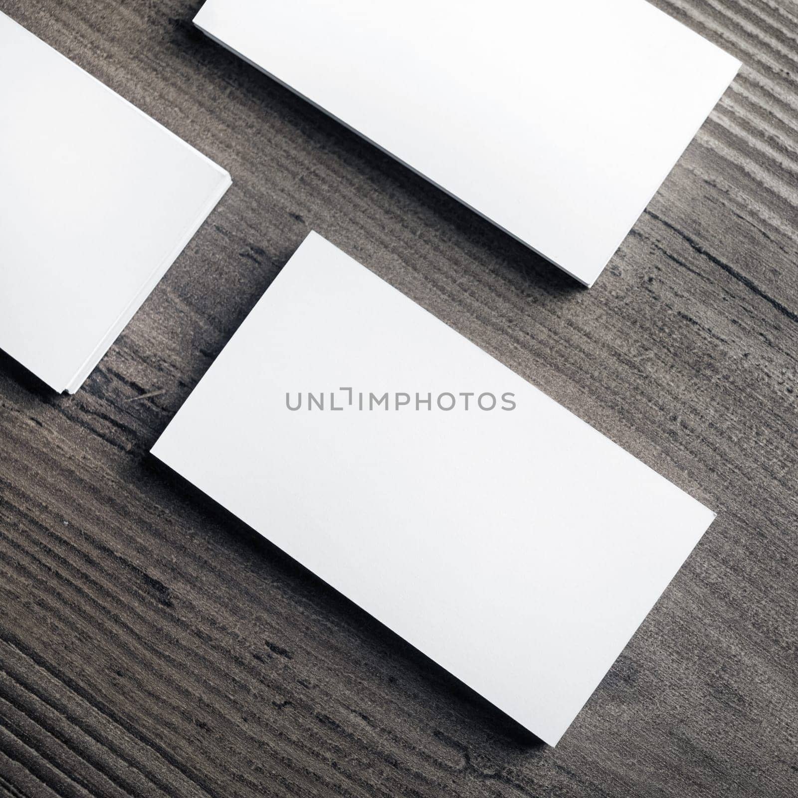 Blank business cards on wood table background. Template for ID. Top view.