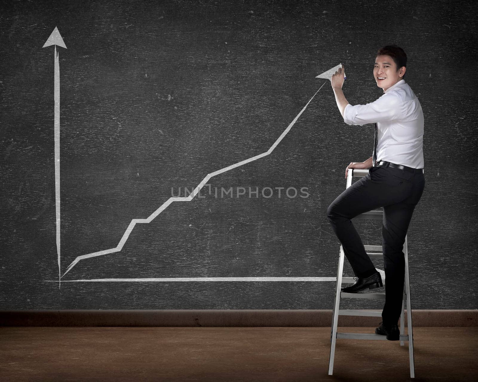 Asian business person drawing chart on the board