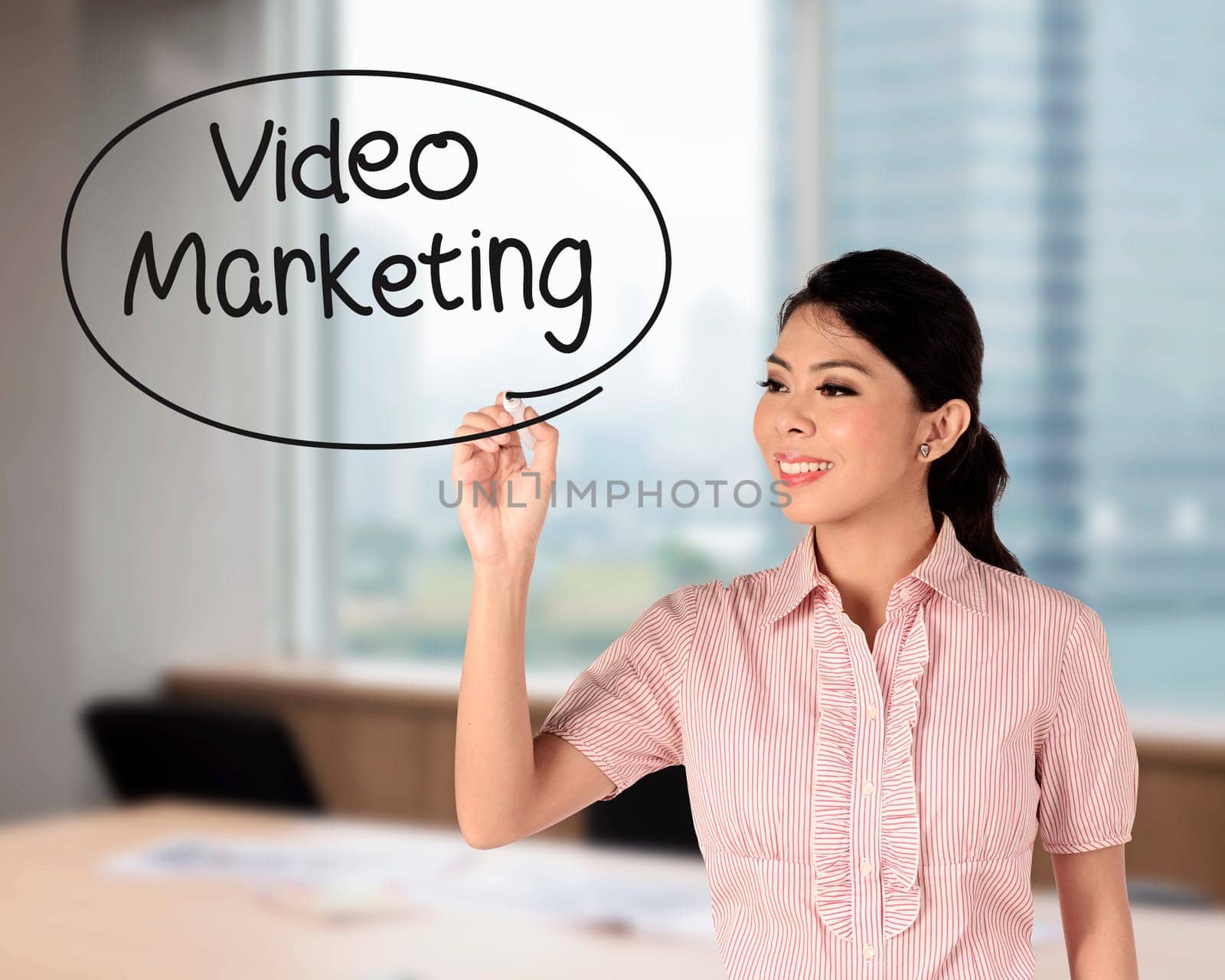 Business woman writing video marketing with handwriting and circle