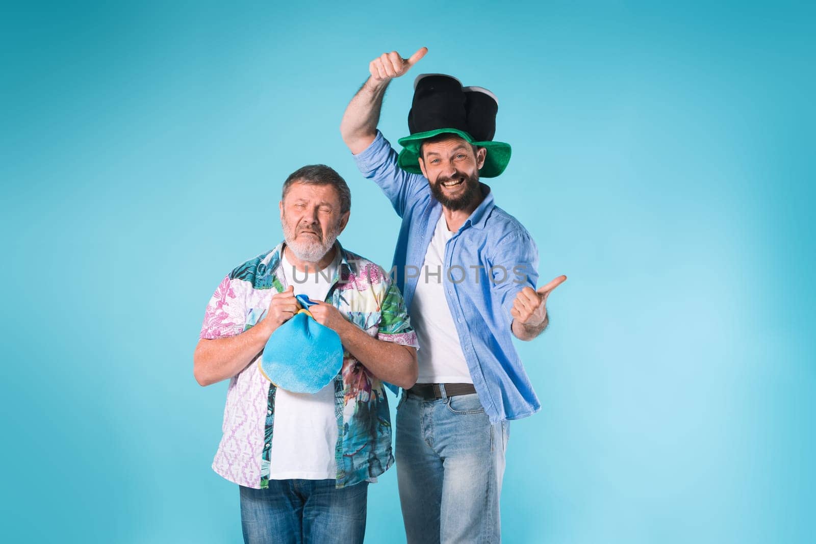 The two emotional football fans over blue background