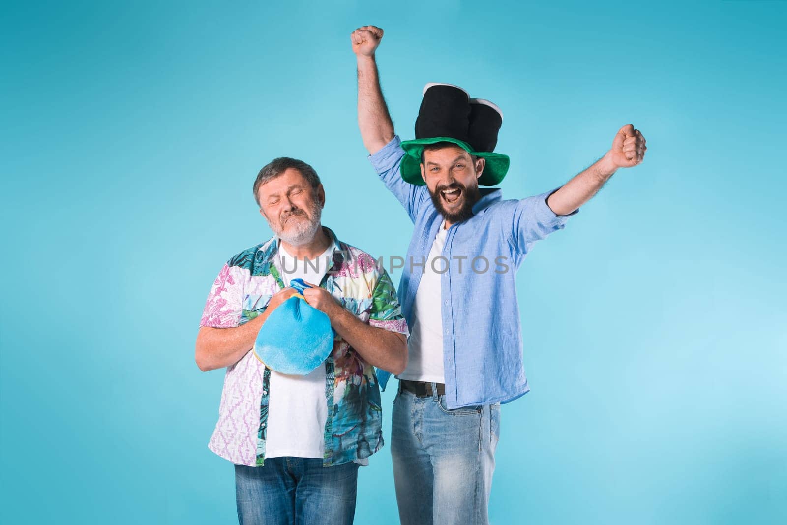 The two emotional football fans over blue background