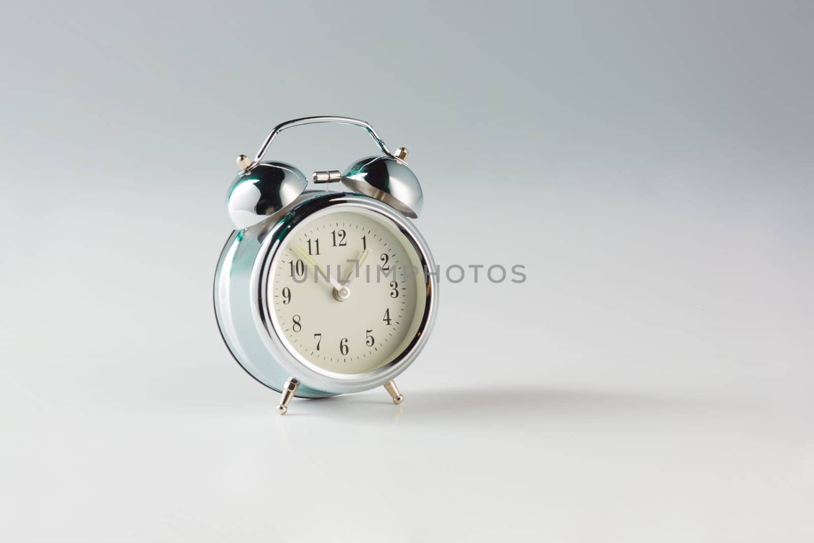 The retro alam clock on gray studio background