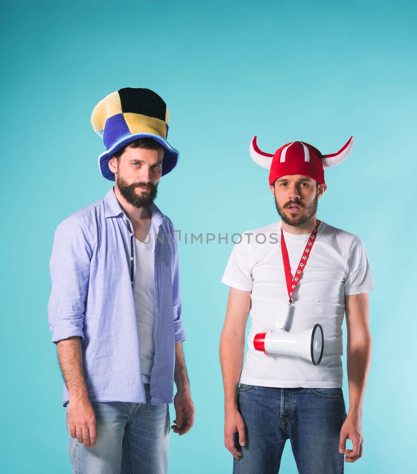 The two football fans with emotions of disappointment over blue background