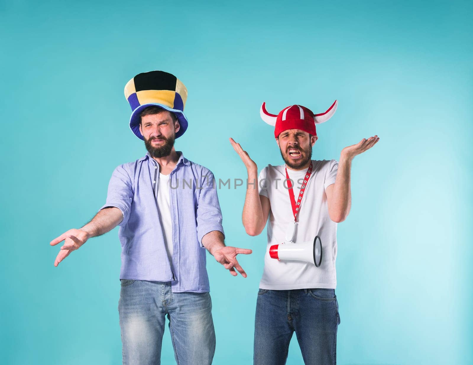 The two football fans with emotions of disappointment over blue background