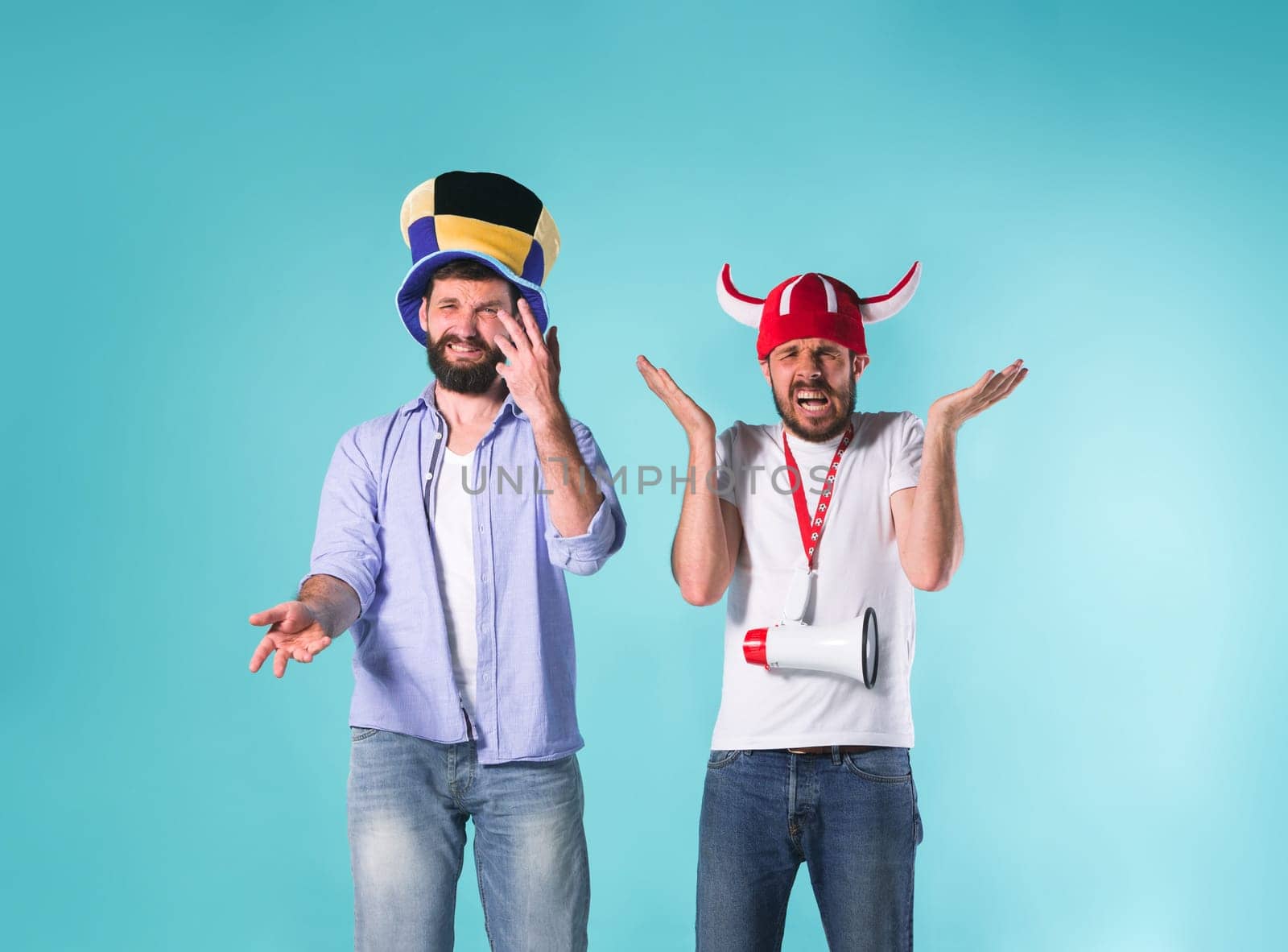 The two football fans with emotions of disappointment over blue background
