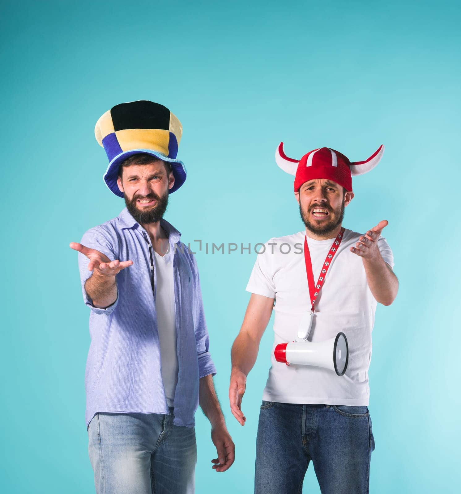 The two football fans with emotions of disappointment over blue background