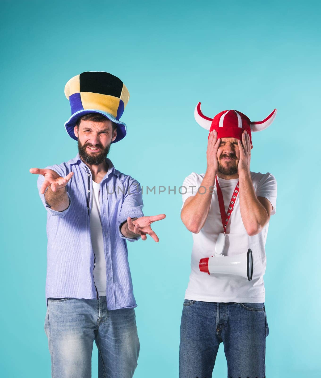 The two football fans with emotions of disappointment over blue background