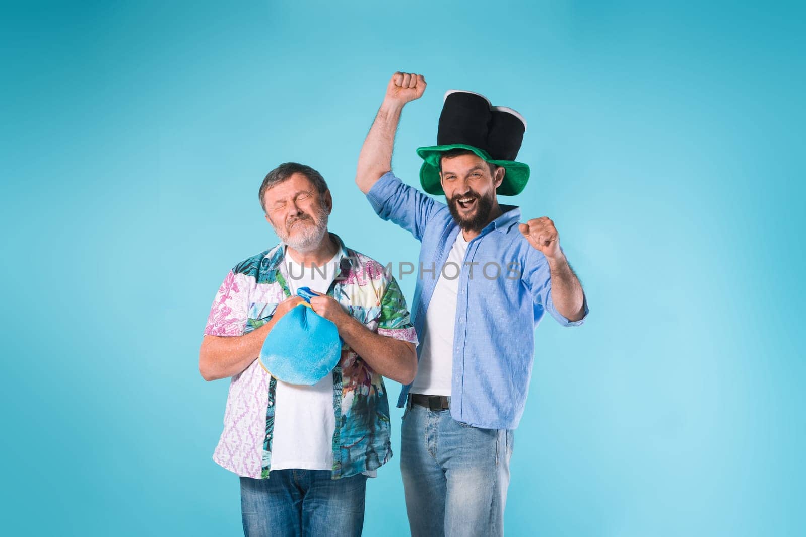 The two emotional football fans over blue background