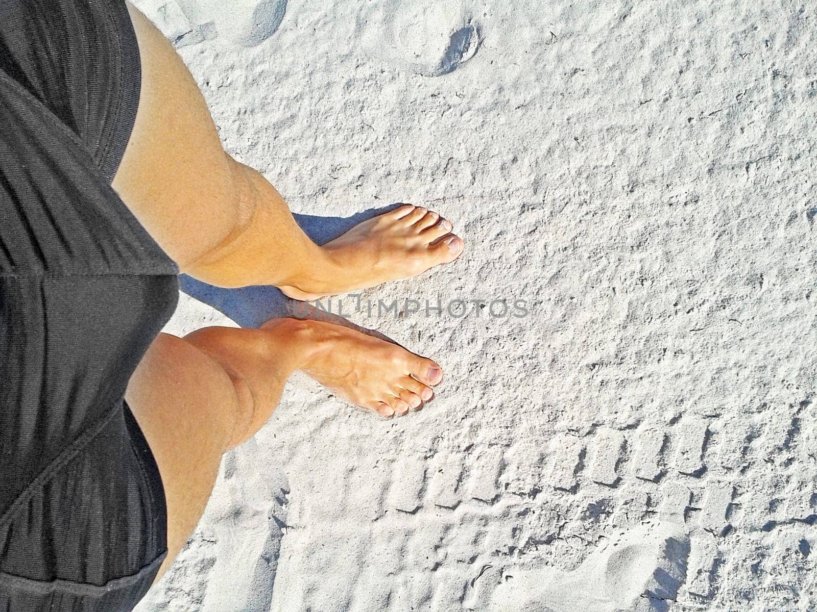 two feet on the beach / sand top view