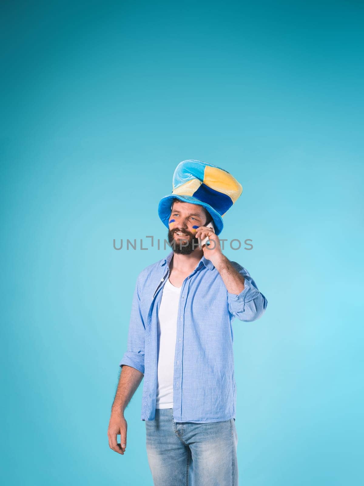 The emotions on face of football fan with hat over blue background