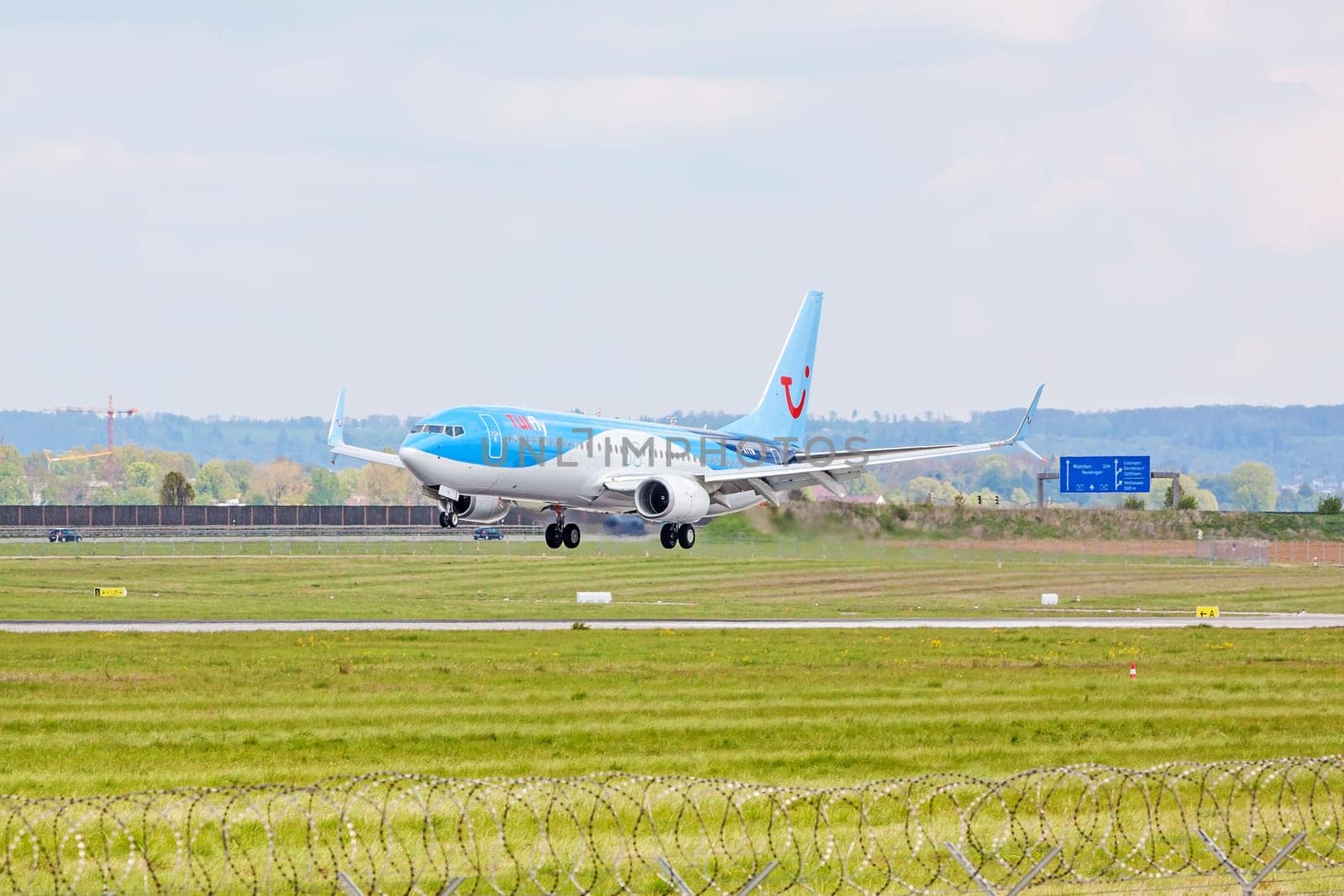 Stuttgart, Germany - April 29, 2017: Airbus airplane A320 from TUIfly on landing approach to airport Stuttgart - green meadow with weather station in front