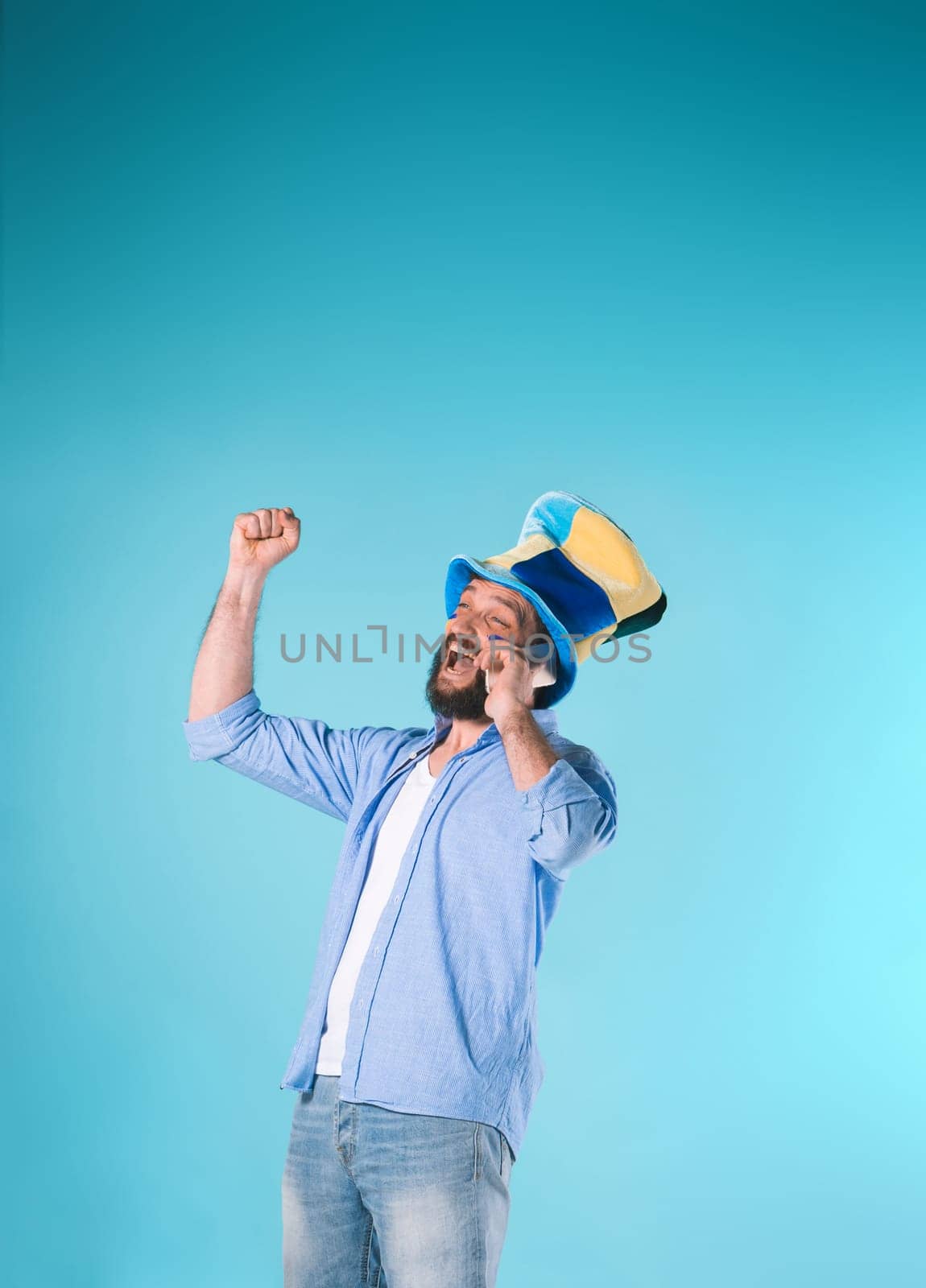 The emotions on face of football fan with hat over blue background