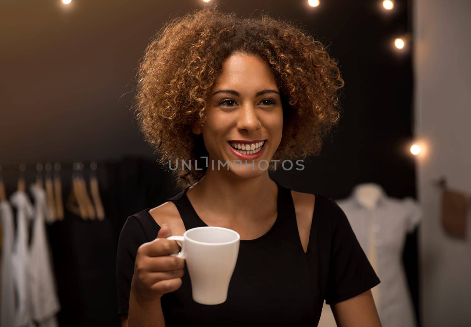 Portrait of a young fashion designer working on her atelier