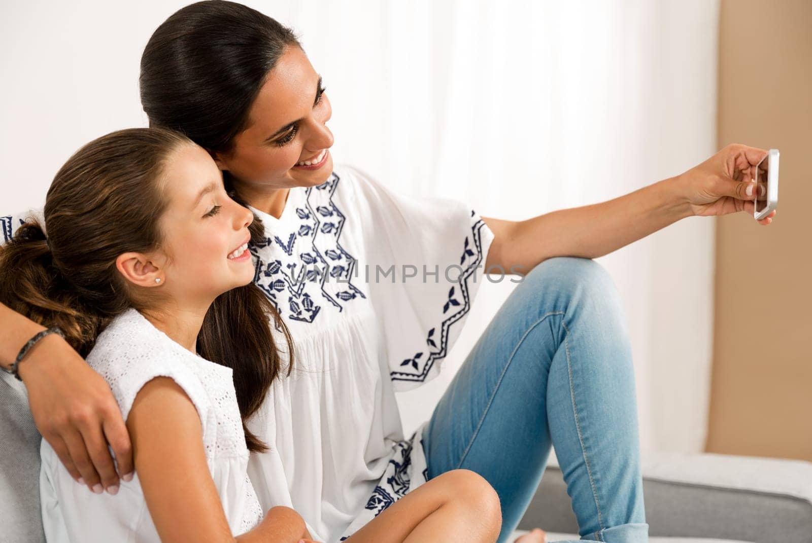 Beautiful Mom and Daughter at home making a selfie