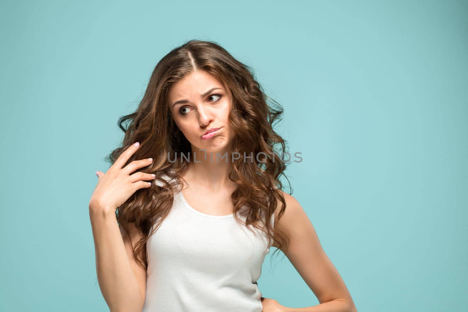 The portrait of disgusted woman on studio background