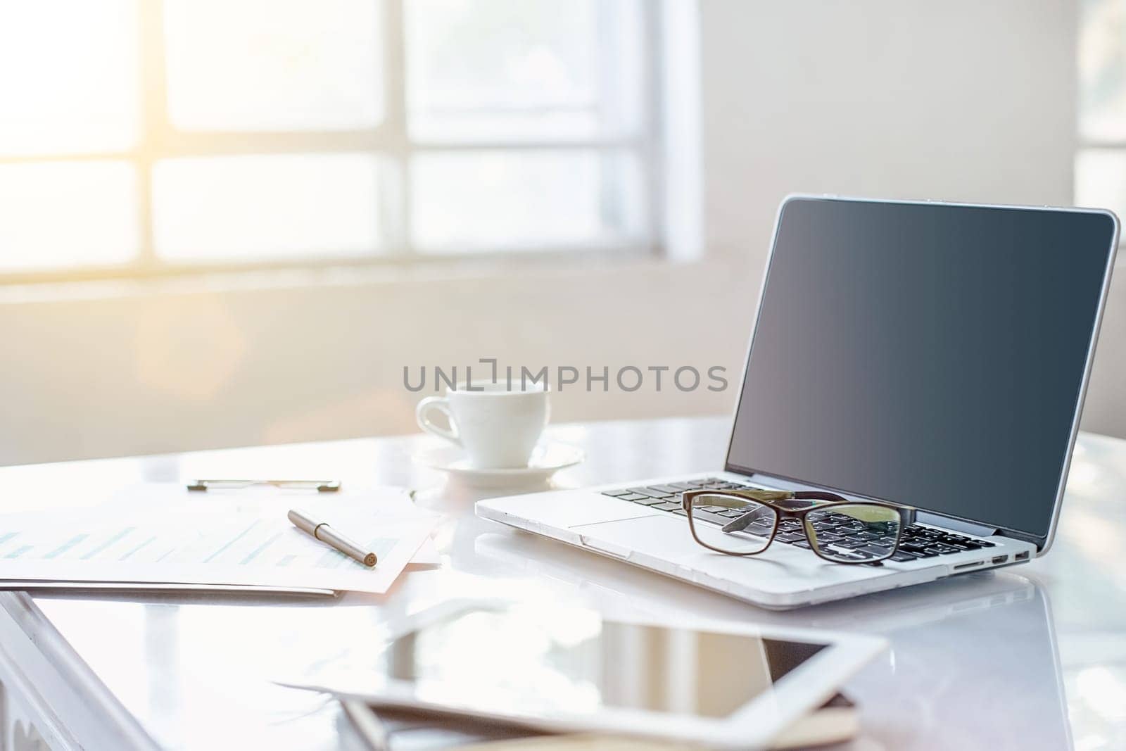 The tipical office desktop with pc, pens, notebook, laptop