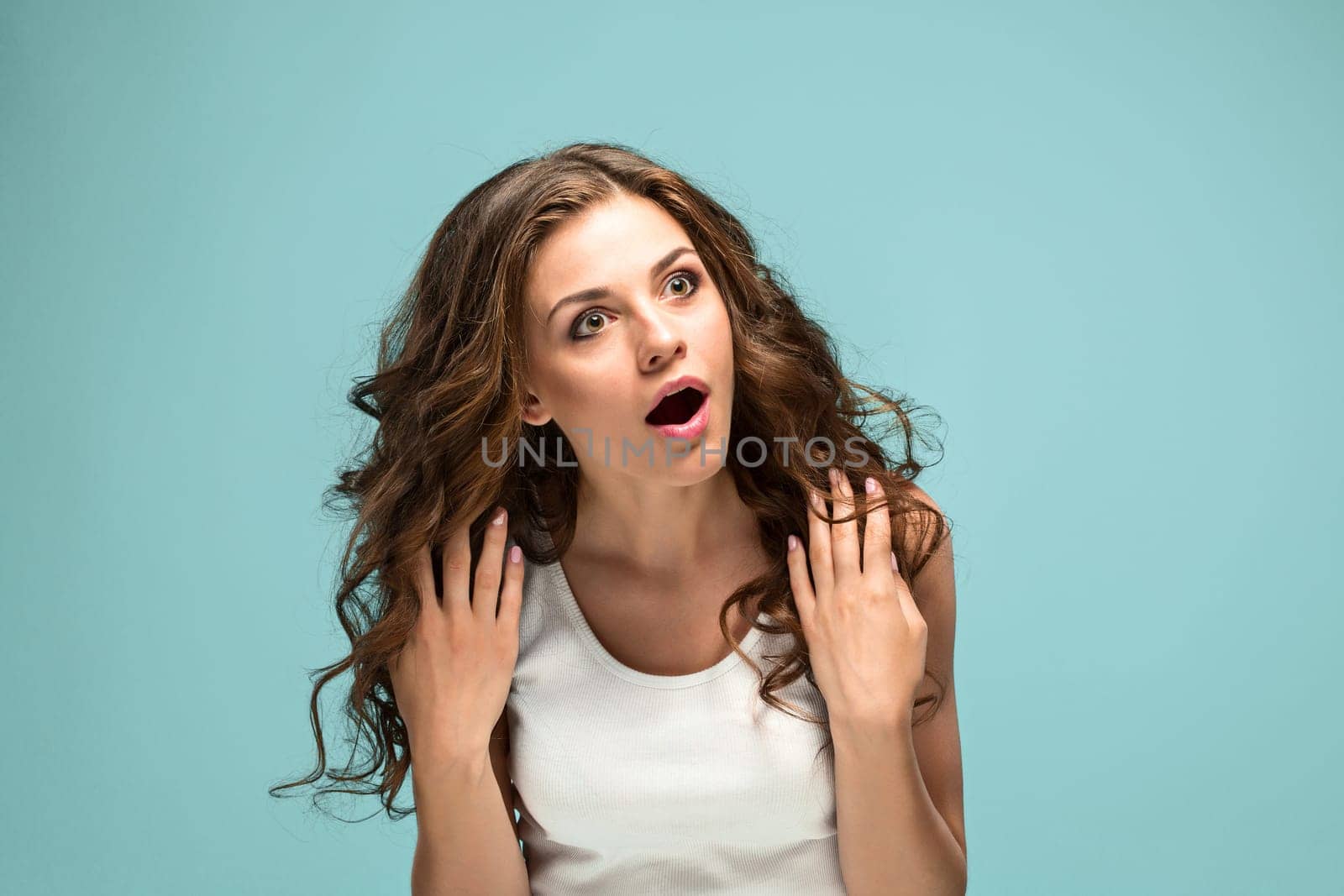 The portrait of Fright young woman with shocked facial expression