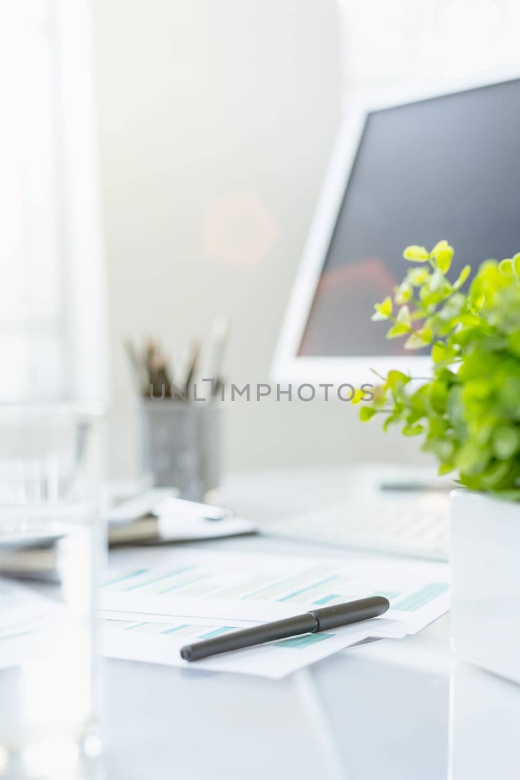 The tipical office desktop with pc, pens, notebook, laptop