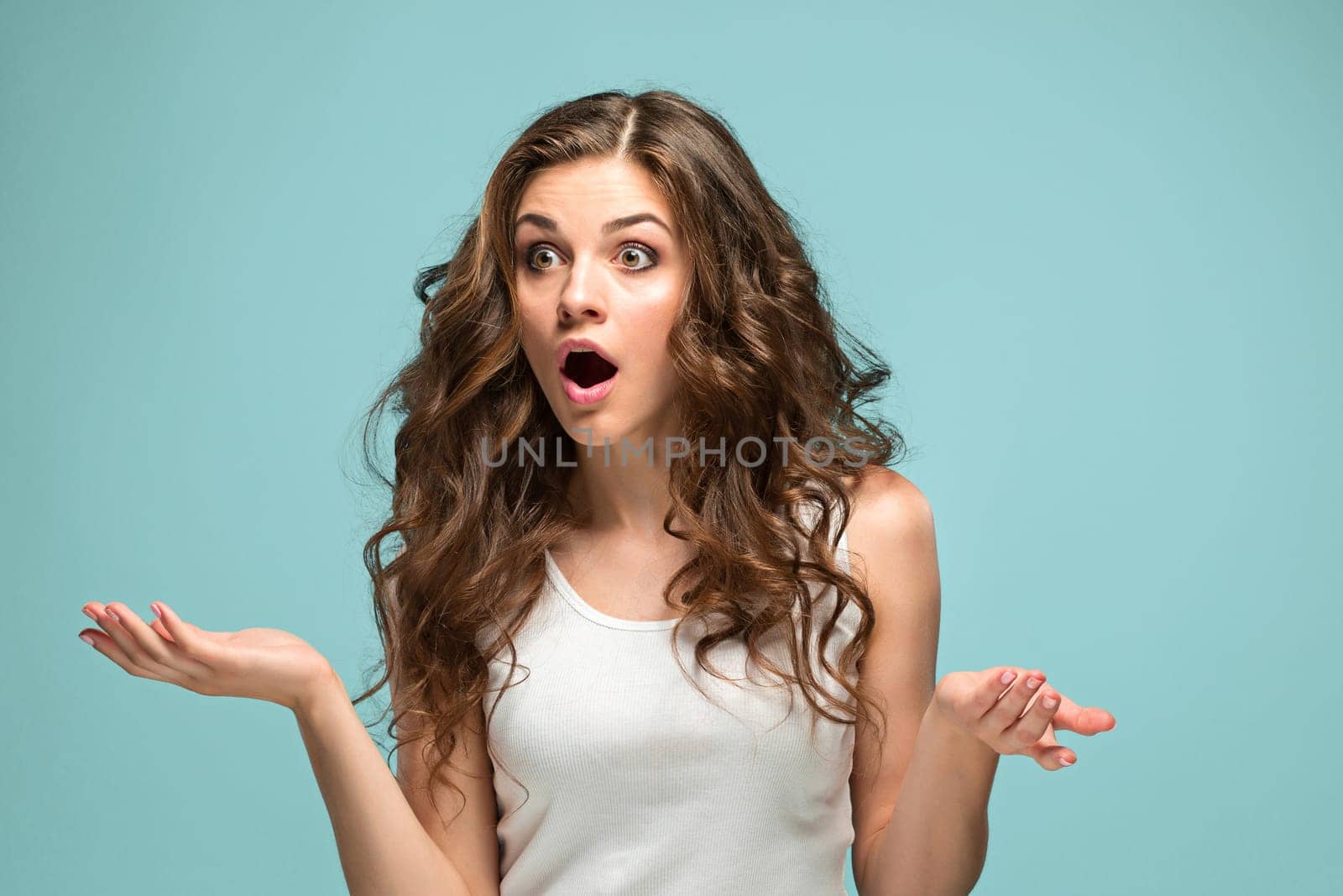 The portrait of young woman with shocked facial expression